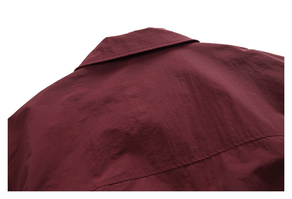 Close-up of a burgundy jacket collar and curved back yoke seam.