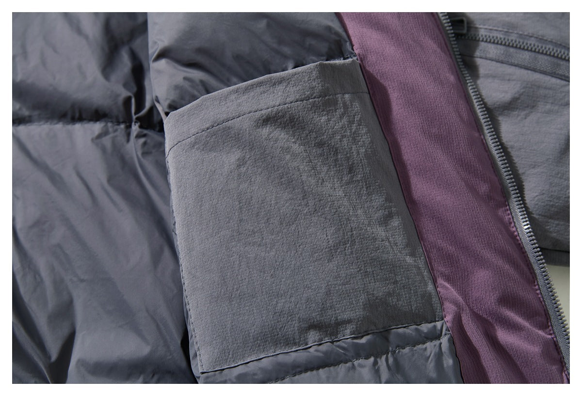Close-up of a gray jacket's interior pocket, plum-colored lining, and zipper.