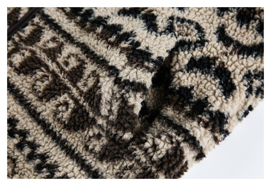 Close-up of a folded seam in plush beige, brown, and black patterned fleece.