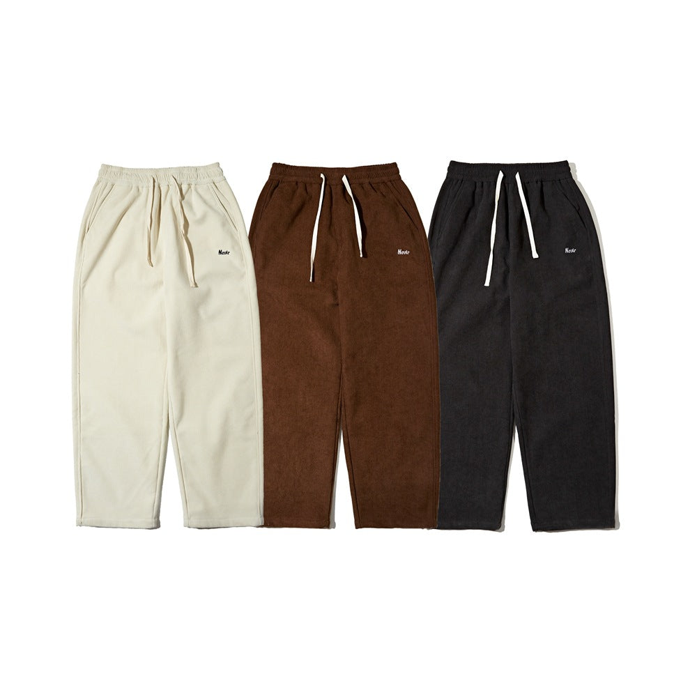 Three pairs of drawstring pants shown front-facing in cream, brown and charcoal.
