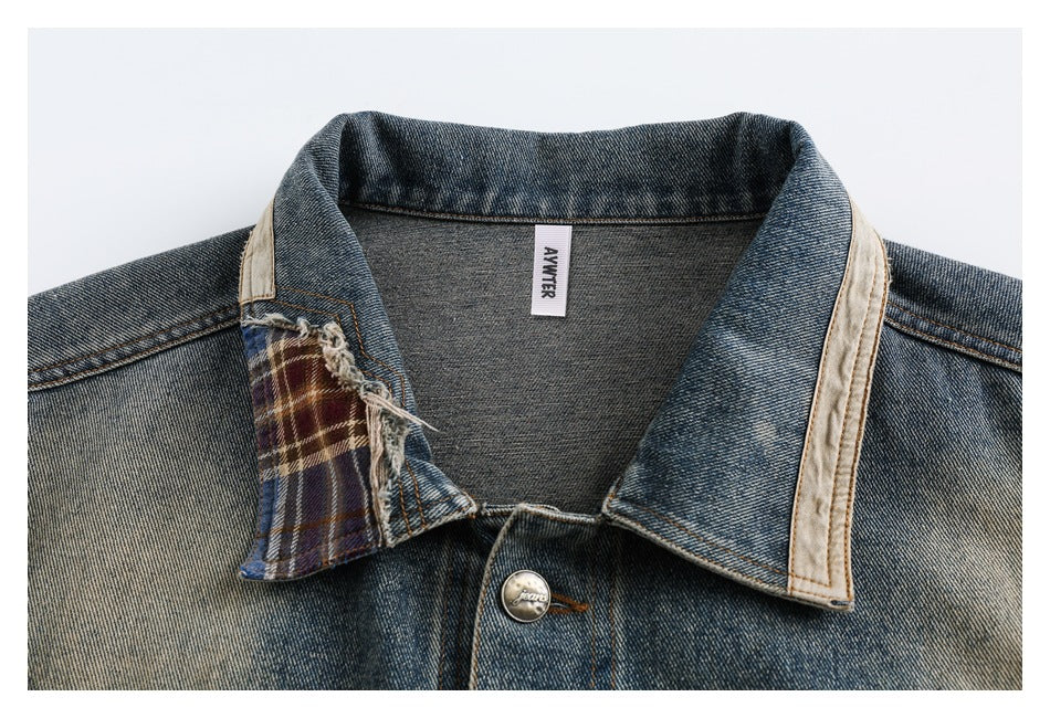 Close-up of the denim jacket's collar, showing a plaid insert, pale lining, and a small neck label.