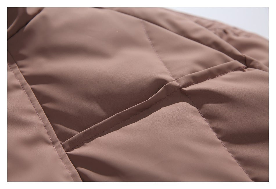 Close-up of the dusty mauve jacket's quilted panels and raised seam stitching.