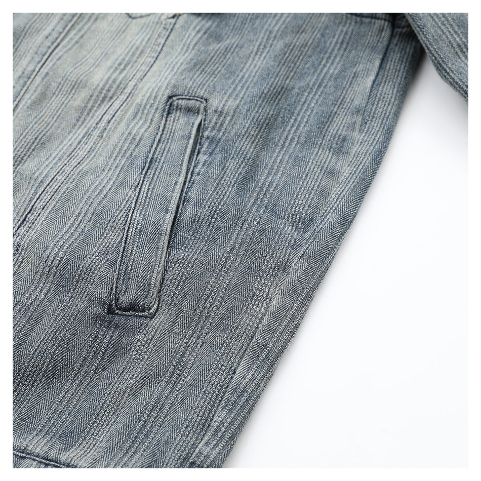 Close-up of a narrow welt pocket on gray-blue striped jacket fabric.
