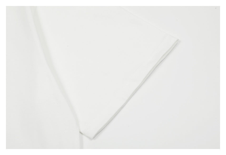 Close-up of a white garment sleeve with a narrow stitched hem.
