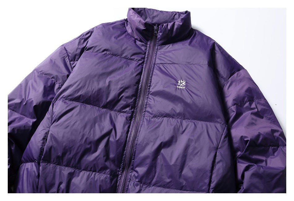 Flat lay of a purple quilted jacket with a stand collar, full front zipper and small white chest logo.