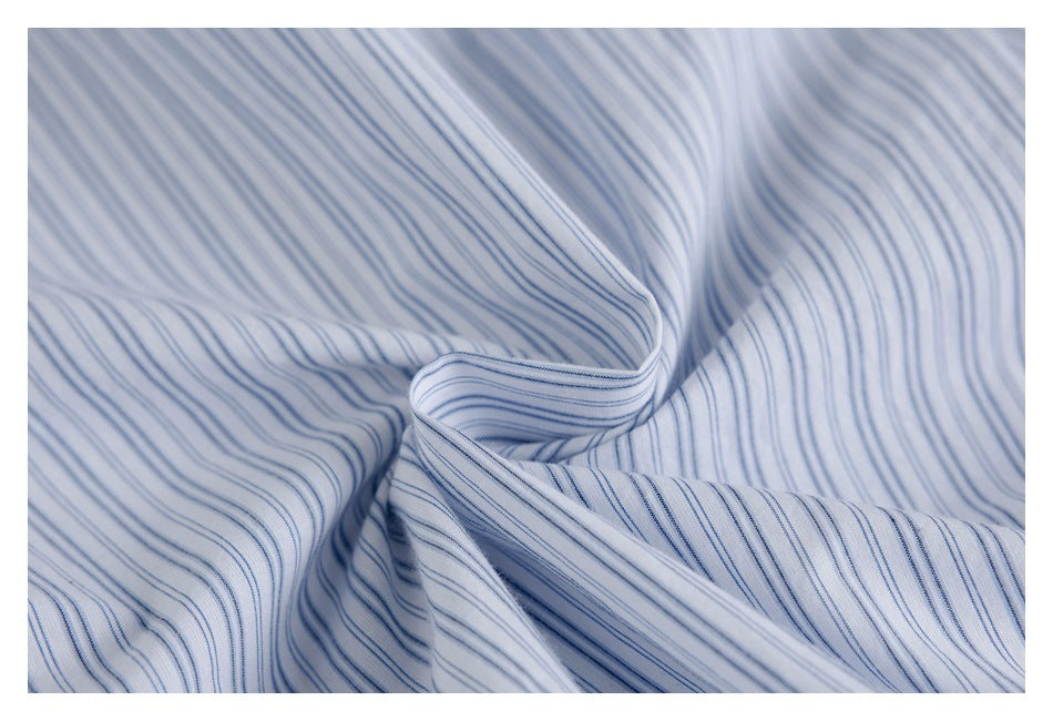 Close-up of white fabric with fine blue stripes gathered into soft folds.