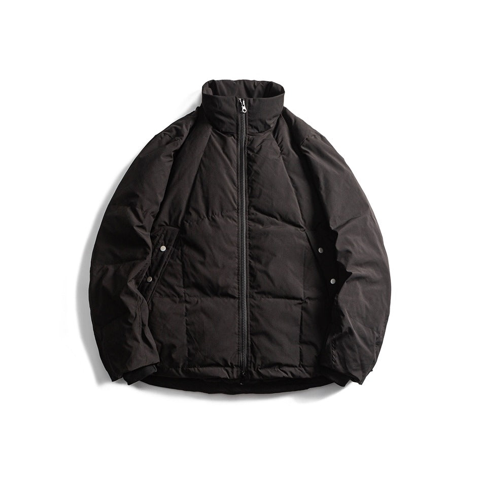 Black quilted stand-collar puffer jacket with front zipper and snap side pockets, flat lay front view