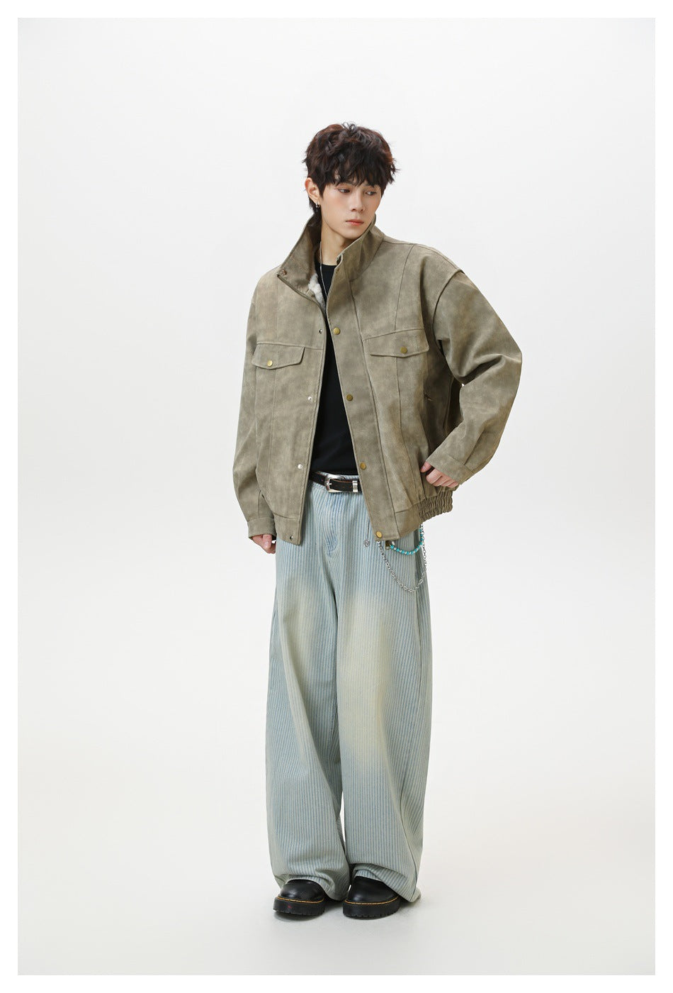 Full-length view of a model wearing a taupe mottled jacket with a stand collar and flap pockets.