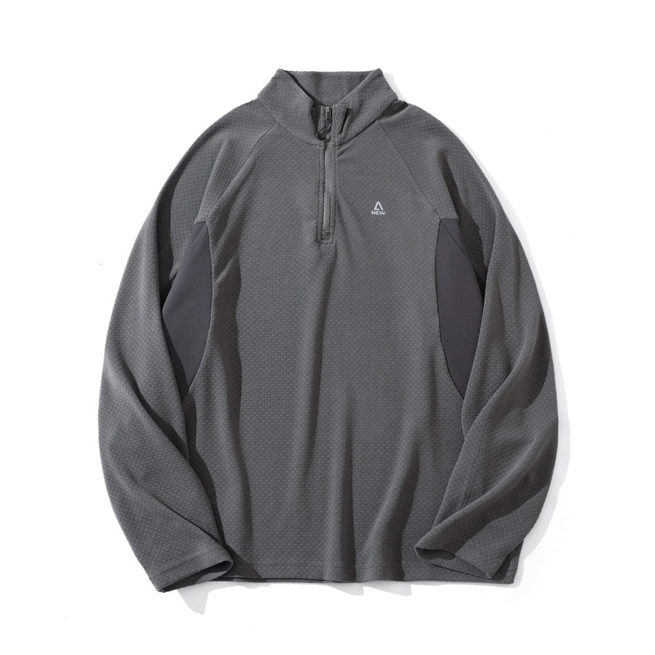 Gray half-zip stand-collar pullover with textured dotted knit, raglan sleeves and darker side panels, flat lay