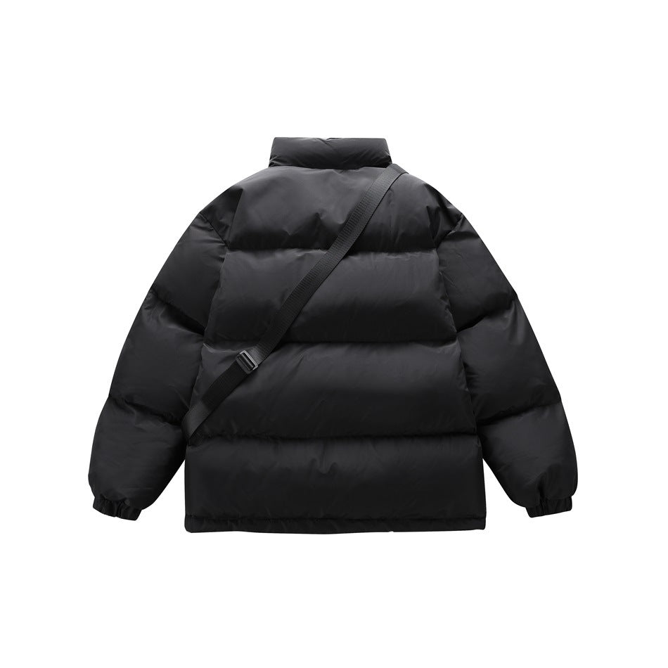 Back view of a black quilted puffer jacket with a diagonal black crossbody strap.