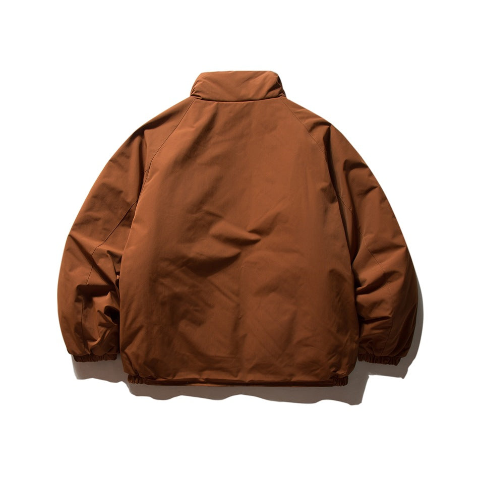 Back view of a rust-brown jacket with a high collar and gathered cuffs and hem.