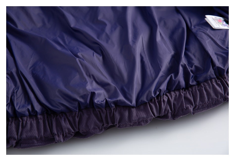 Close-up of a dark purple garment with a gathered elastic hem and a small tag near the edge.