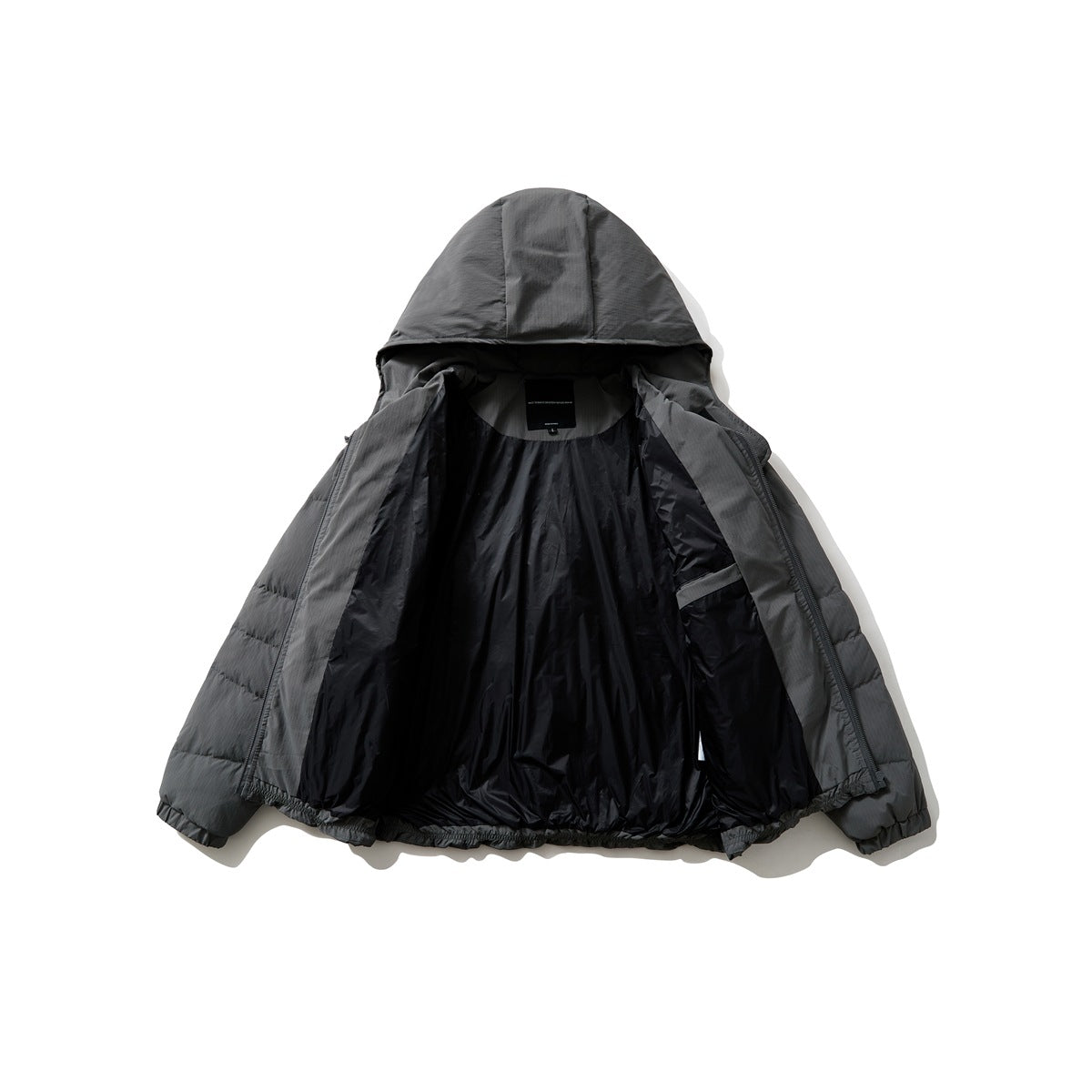 Charcoal-gray hooded puffer jacket opened to show its dark lining and interior pocket.