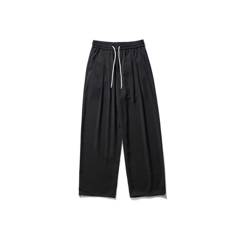 Black wide-leg pants with an elastic waistband, white drawstrings, and angled front pockets.