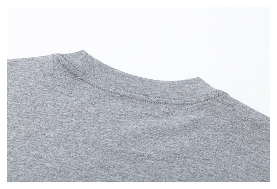 Close-up of the crew neckline seam on a heather gray knit garment.
