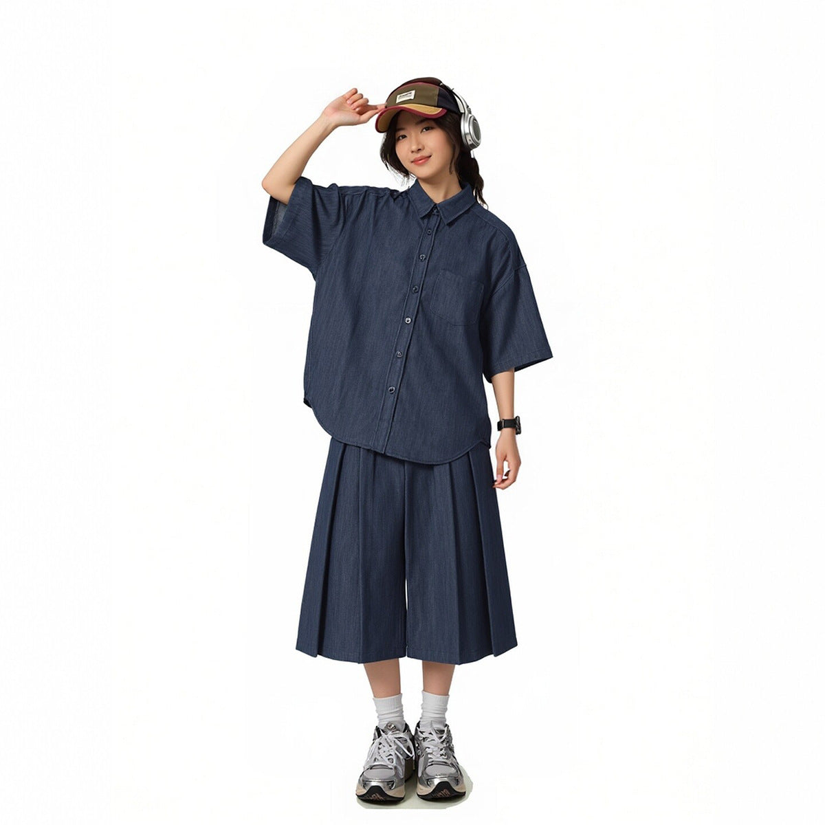 Model wearing a navy short-sleeve button-up shirt with matching wide cropped pants.