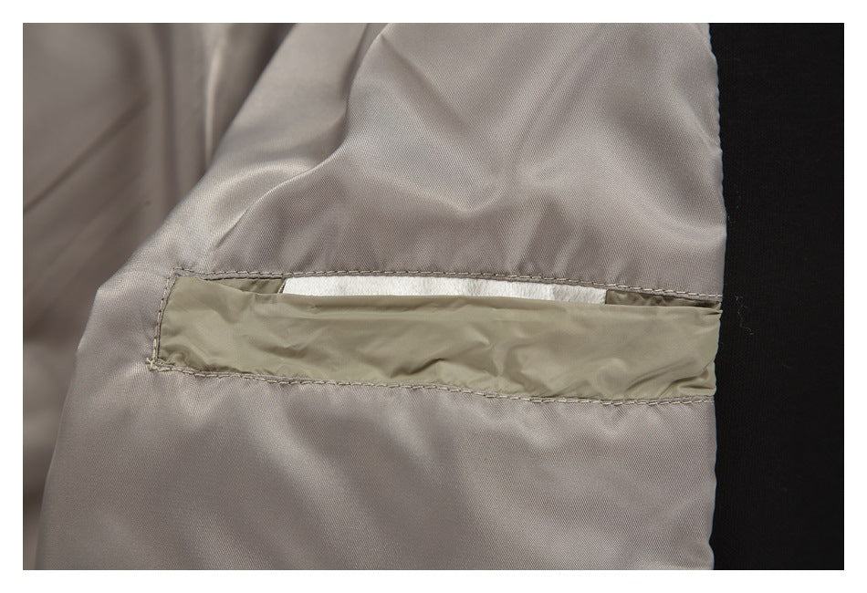Close-up of an interior pocket opening and seams in the taupe jacket lining.