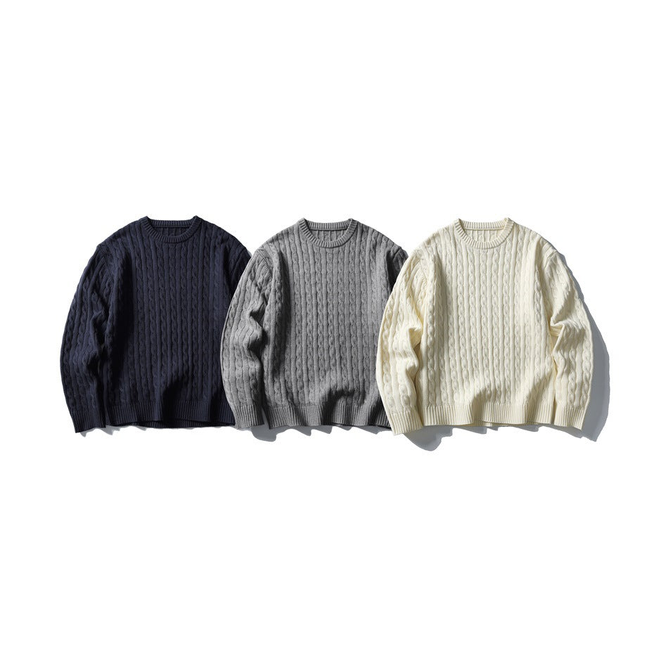 Three cable-knit crewneck sweaters shown from the front in navy, gray, and ivory.