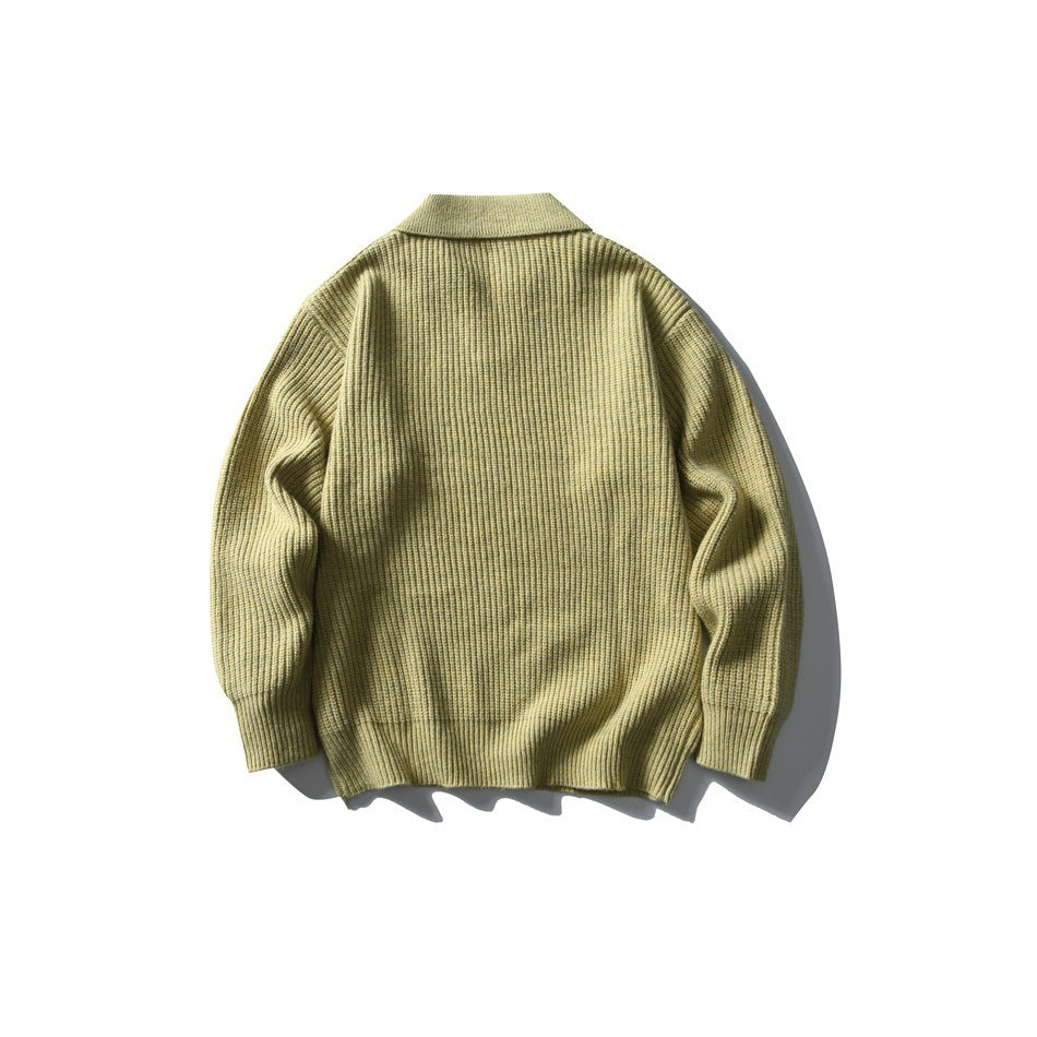 Back view of an olive-beige ribbed knit sweater with a folded collar and long sleeves, laid flat on white.