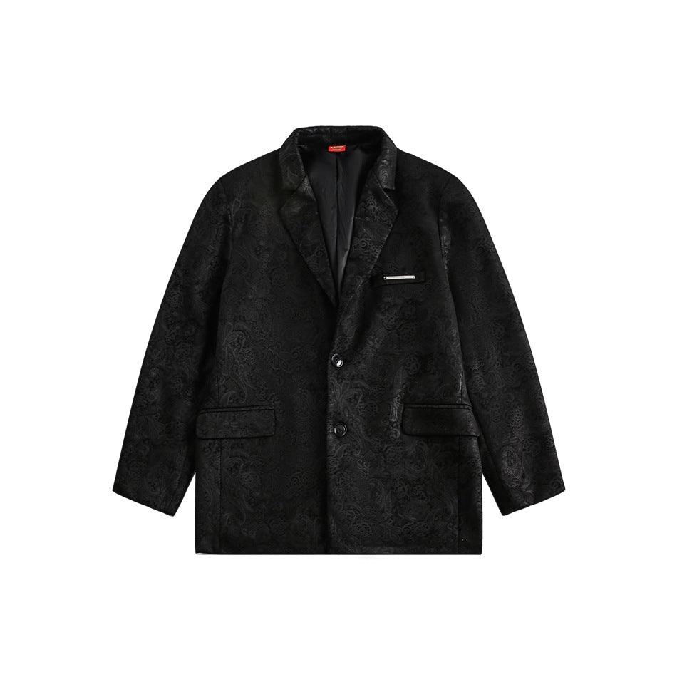 Front view of a black blazer with an allover tonal floral pattern, notched lapels, two buttons, and flap pockets.