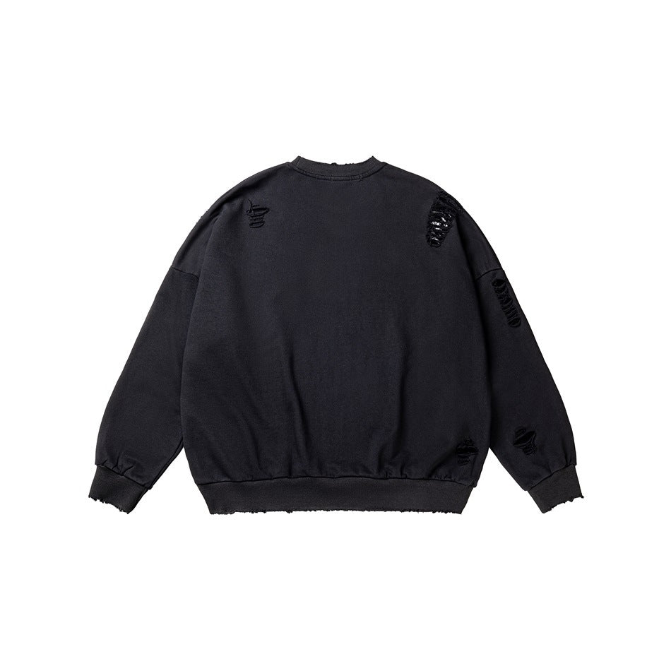 Back of a black crewneck sweatshirt with distressed slashes on the upper back and sleeve, plus ribbed cuffs and hem.