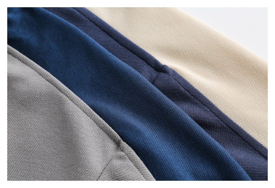 Close-up of textured gray, blue, navy, and cream fabric panels.