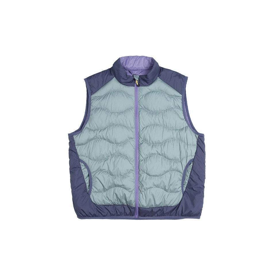 Blue quilted zip vest with sage-teal wavy quilted panels, navy shoulder and side panels, and purple zipper