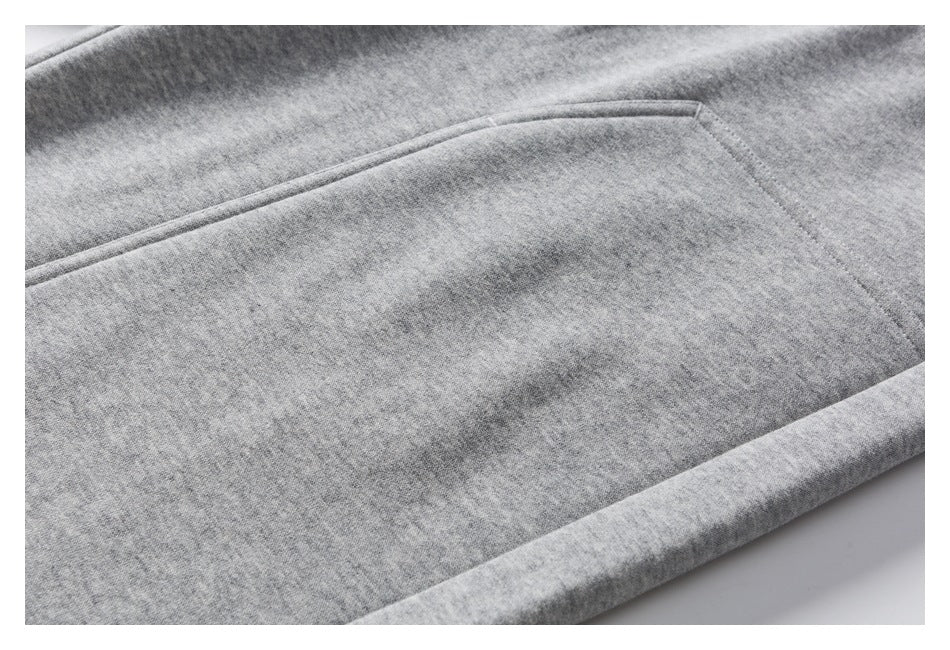 Close-up of a gray heathered pants pocket with stitched edges.