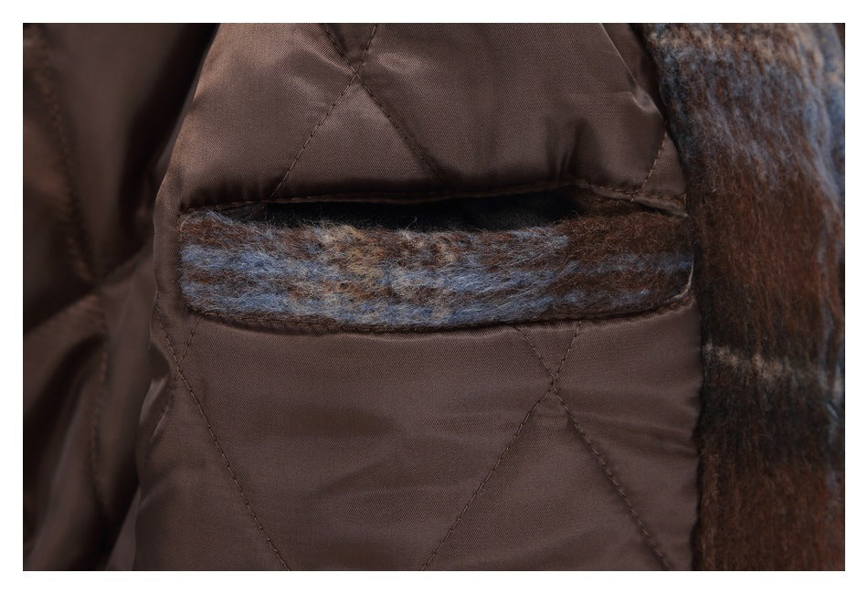 Close-up of the coat's brown quilted lining and a narrow plaid-trimmed interior pocket.