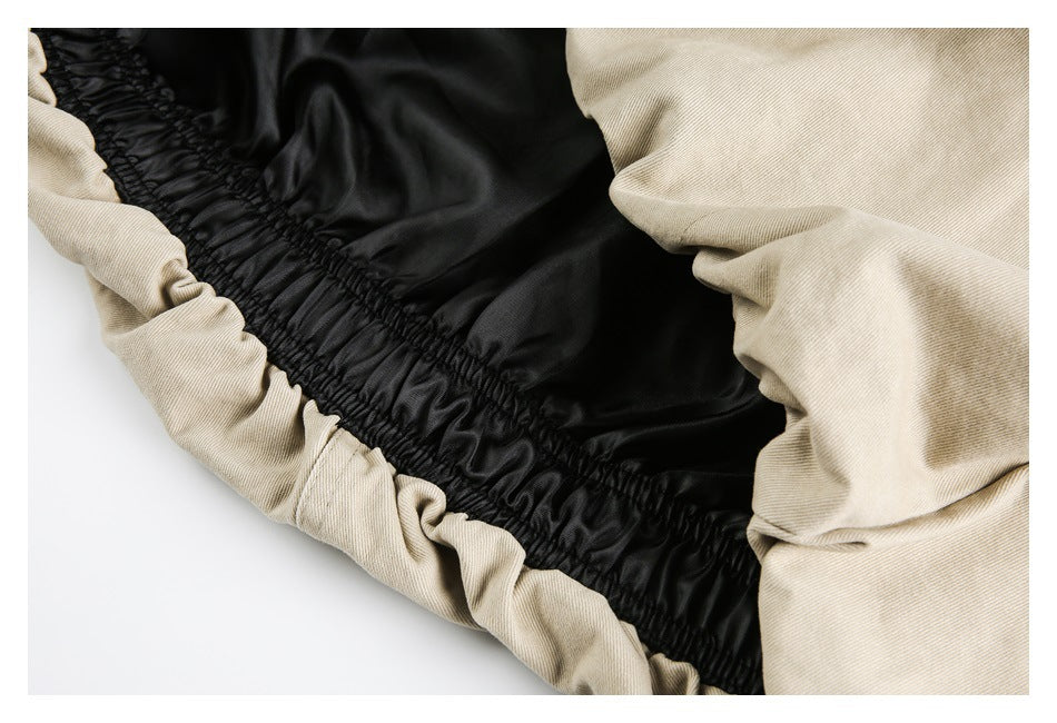 Close-up of black lining and gathered elastic inside a beige garment.