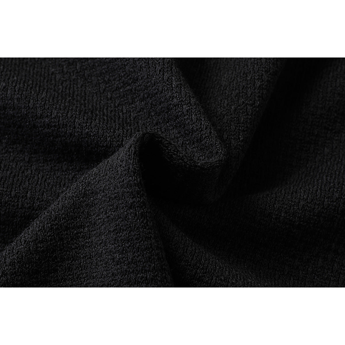 Extreme close-up of the textured black T-shirt fabric.