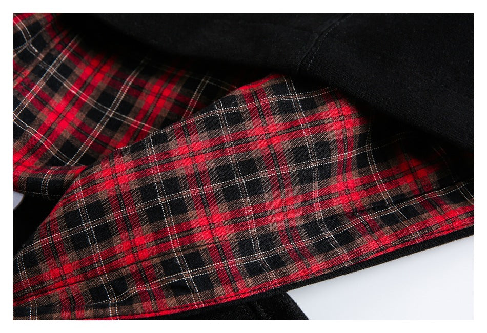 Close-up of the hoodie’s red, black and white plaid lining against the black outer fabric.
