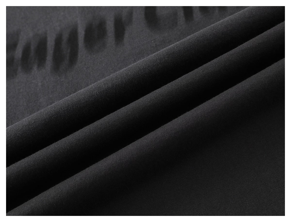 Close-up of black fabric arranged in soft folds.