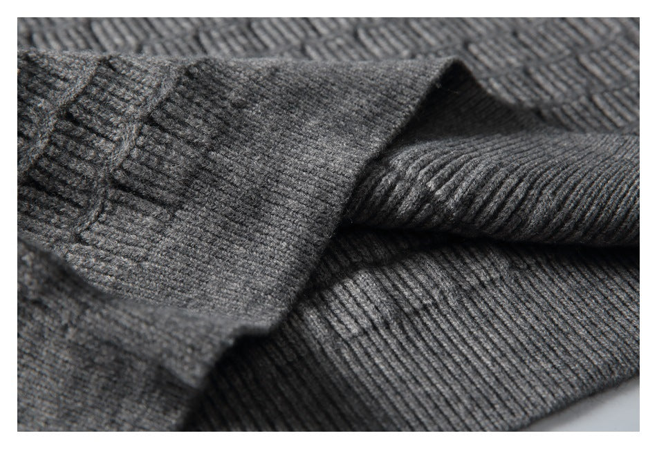 Close-up of a ribbed sleeve cuff against the sweater’s textured knit.