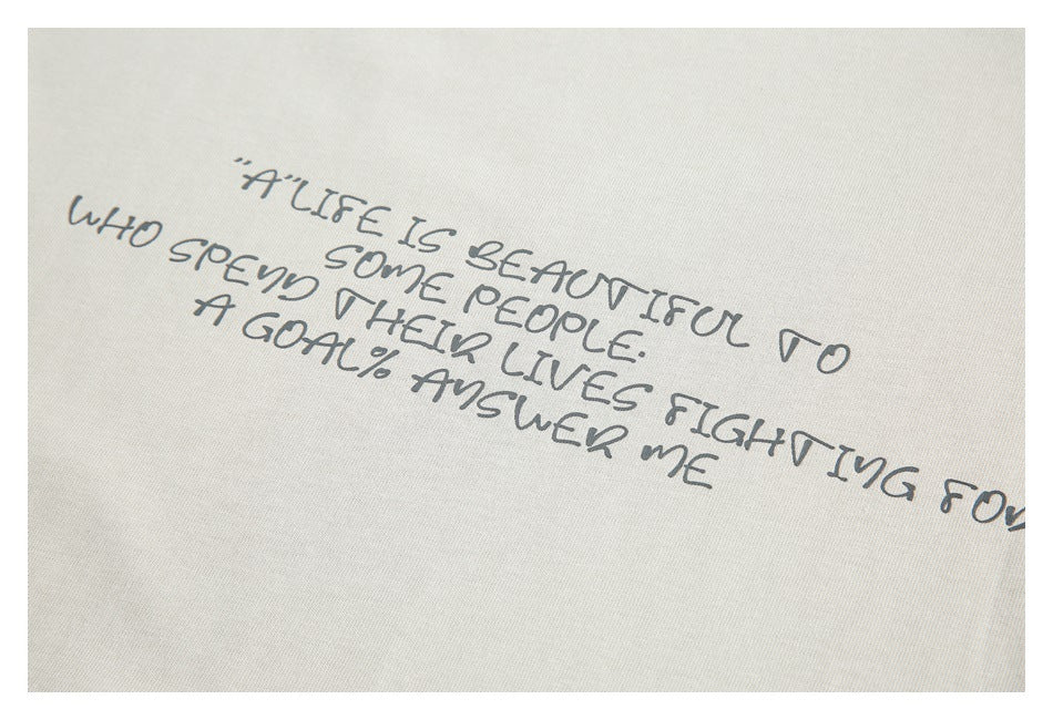 Close-up of a handwritten English quote printed across ivory fabric.