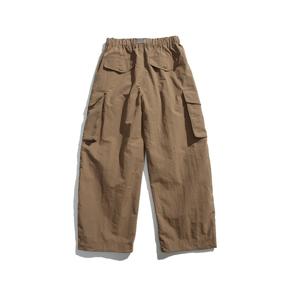 Khaki wide-leg cargo pants back view with elastic waistband, button-flap back pockets and side cargo pockets