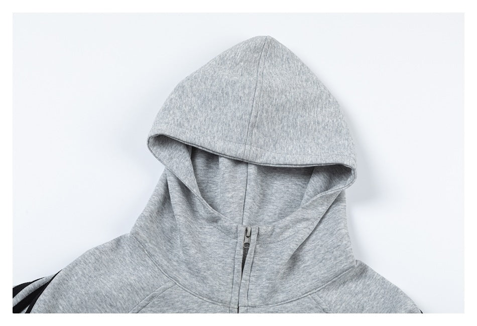 Close-up of a heather gray zip-up hoodie showing the hood and upper front zipper.