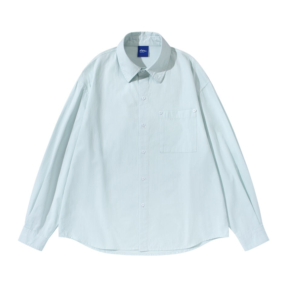 Light blue long-sleeve button-up shirt with chest pocket, flat lay front view