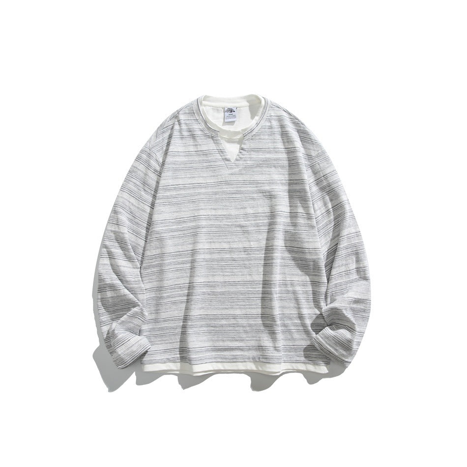 Gray and white striped long-sleeve sweatshirt with notched V-neck and white layered hem, flat lay