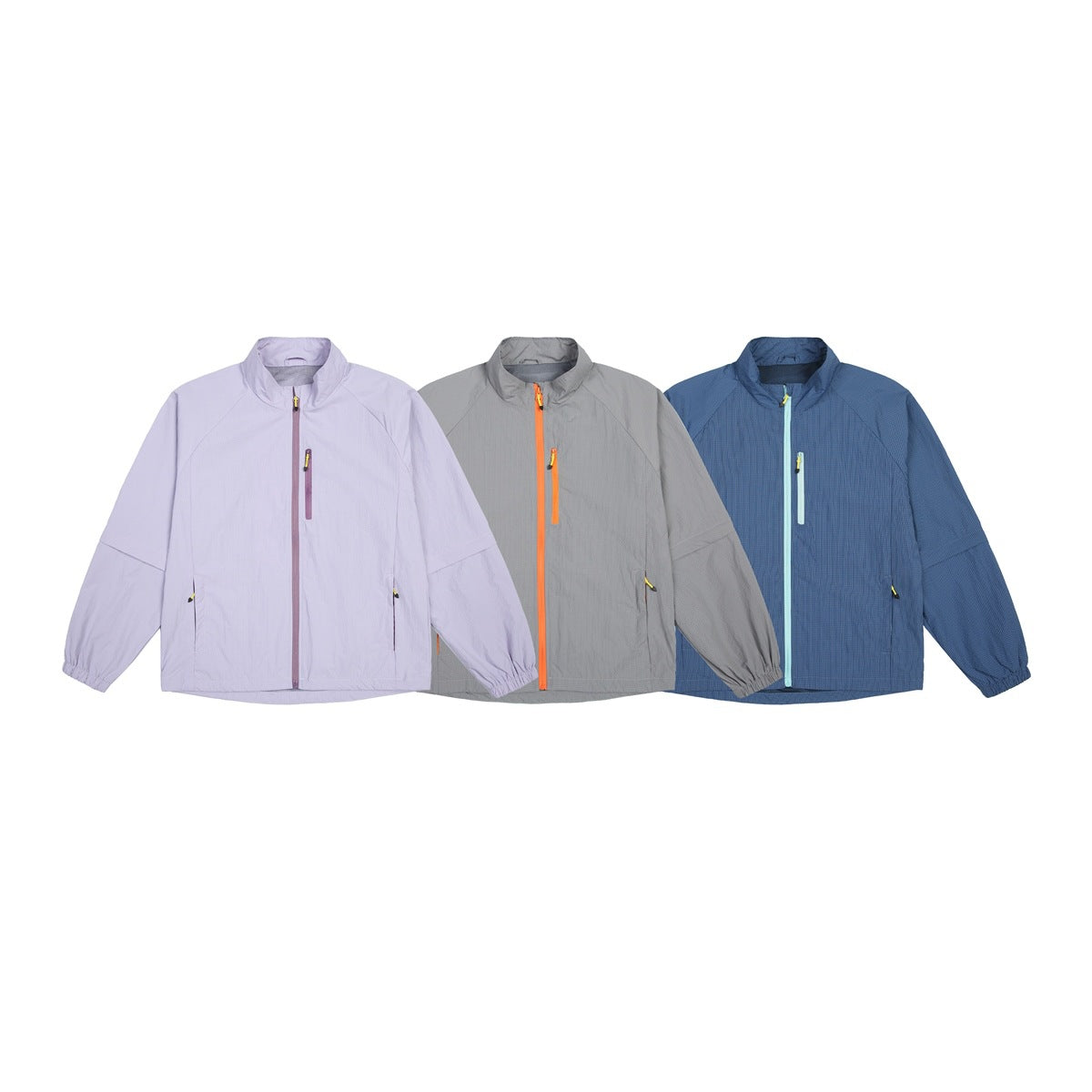 Three front-view zip jackets shown in lavender, gray with orange zippers, and blue with pale aqua zippers.