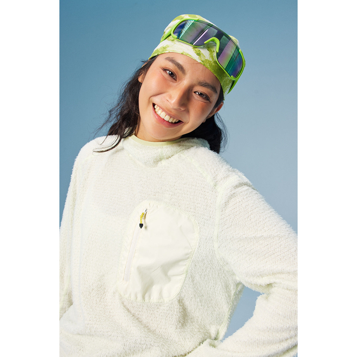 Model wearing an off-white textured pullover with a large zippered chest pocket.