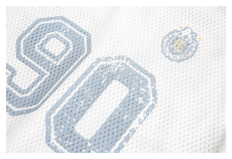 Tight close-up of a pale blue-gray number graphic and crest on white mesh fabric.