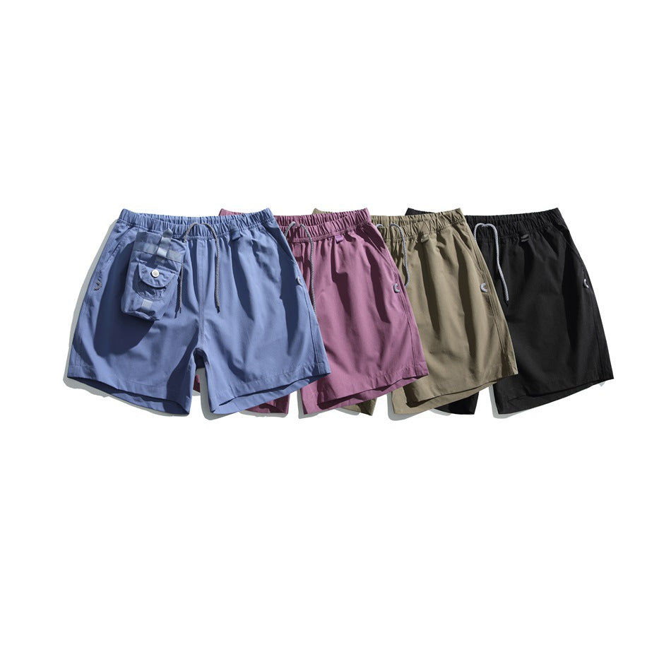 Four pairs of utility shorts shown together in slate blue, mauve, khaki, and black.
