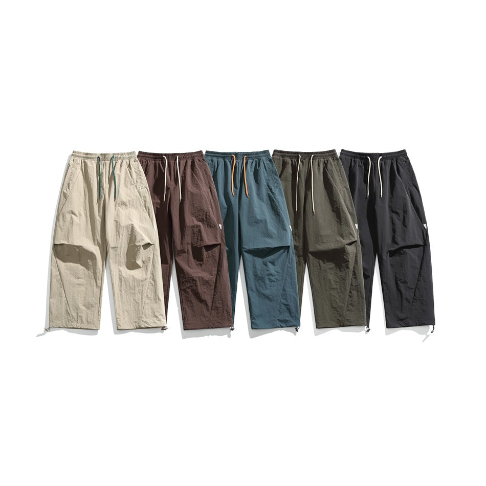 Six pairs of loose pants displayed in beige, brown, blue, olive, and black colorways.
