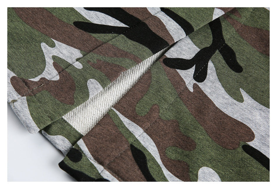 Close-up of a seam and folded edge on the camouflage garment, with the lighter inner side visible.