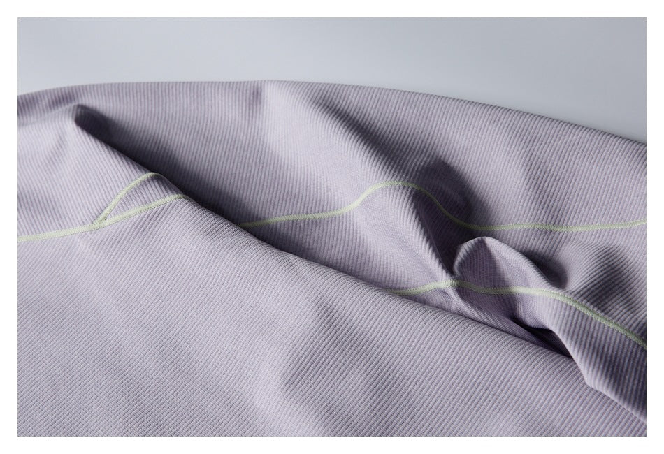 Close-up of pale lavender ribbed fabric with a light green seam.