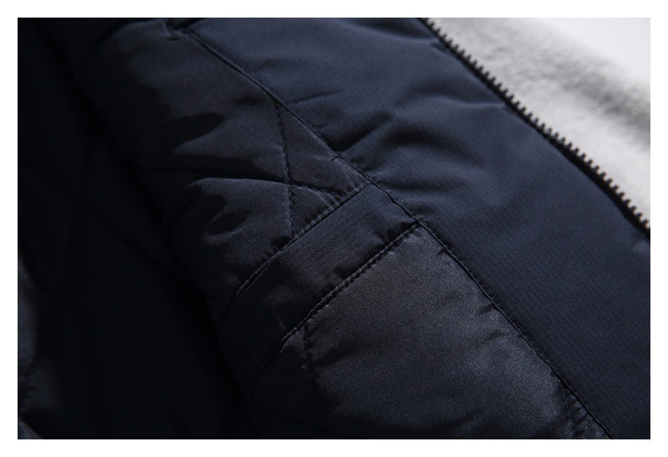 Close-up of dark navy quilted lining and stitched seams beside a zipper and gray fleece.