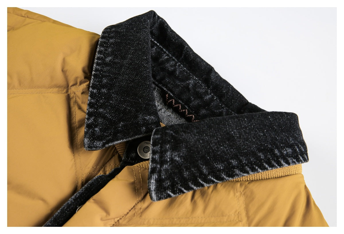 Close-up of the dark pointed collar and snap closure on a mustard quilted jacket.