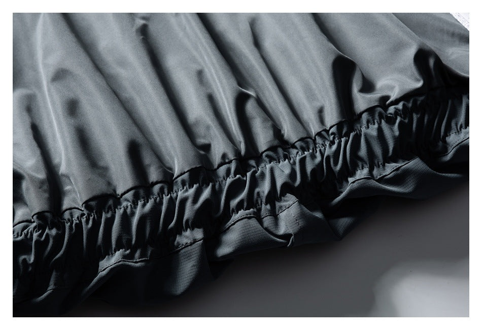 Close-up of the slate-gray jacket's gathered elastic hem and lower edge.