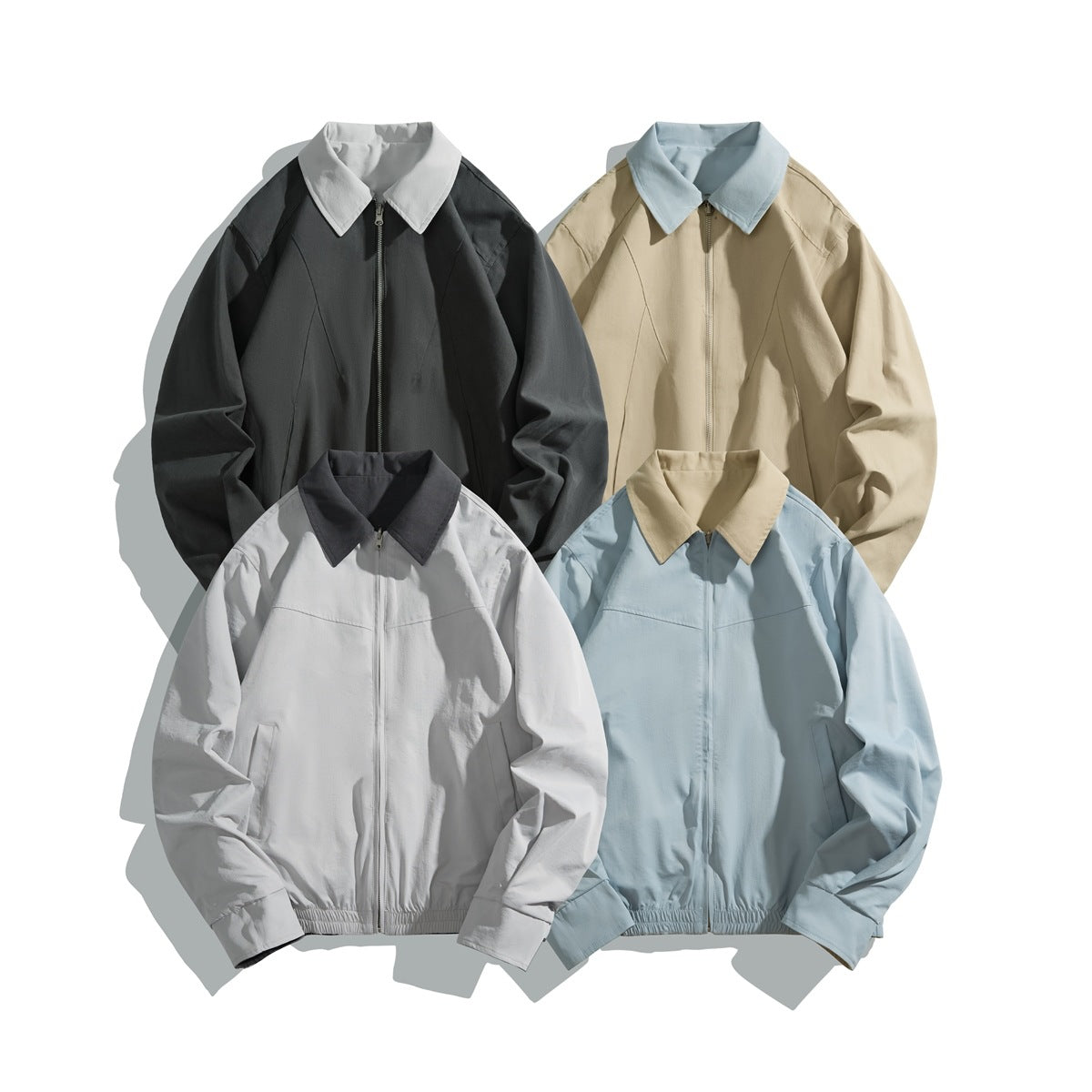 Four zip-front jackets arranged together in charcoal, beige, light gray, and pale blue with contrasting collars.